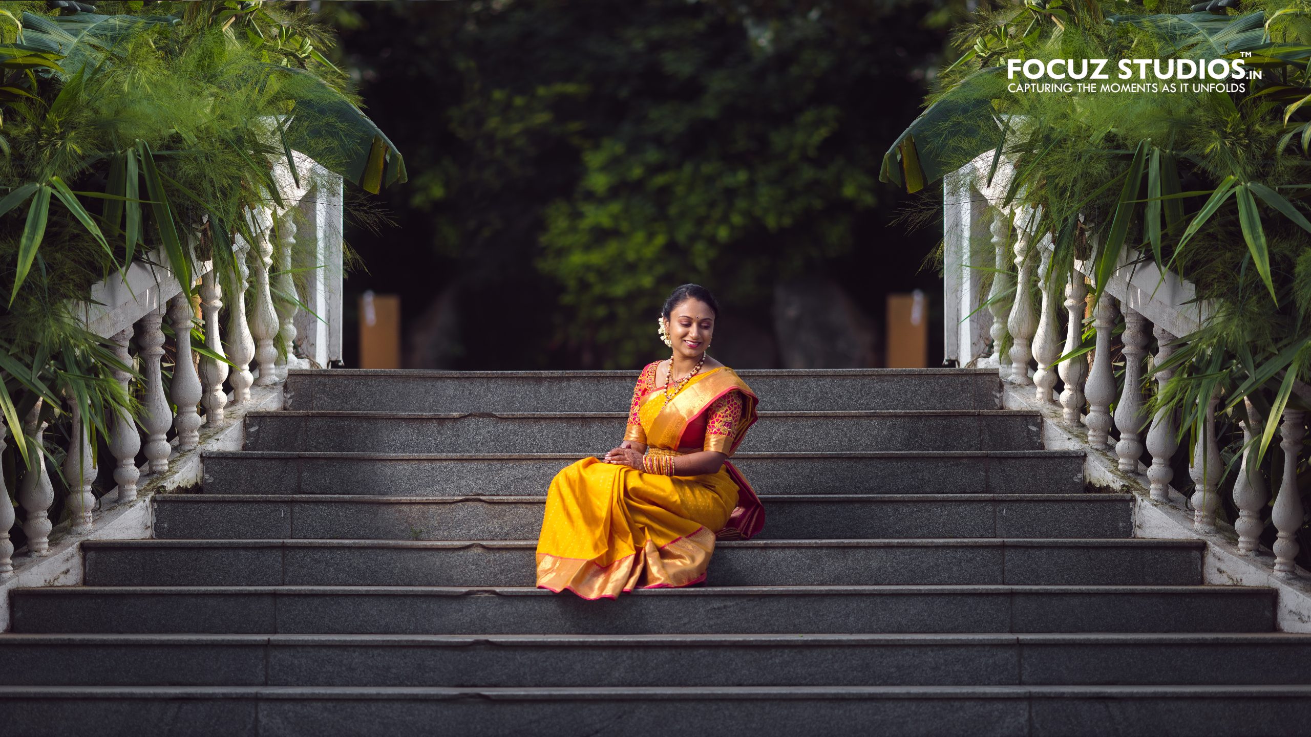 Bride seated on the steps in traditional attire
