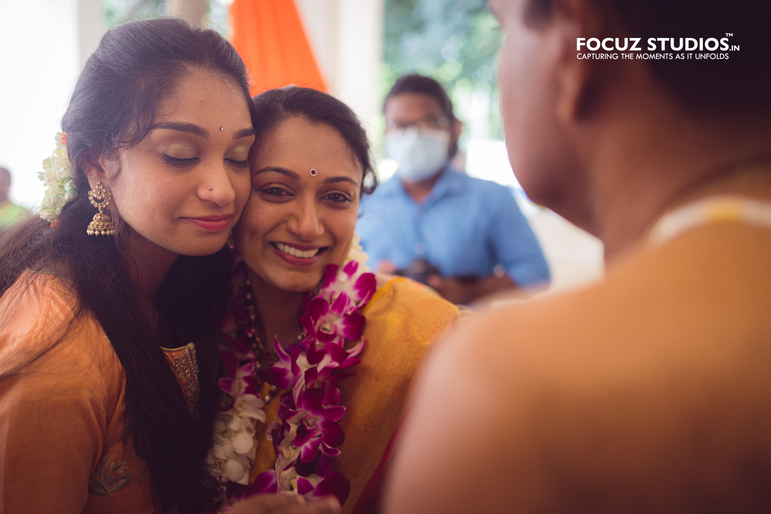 Bride sharing an emotional moment with her sister