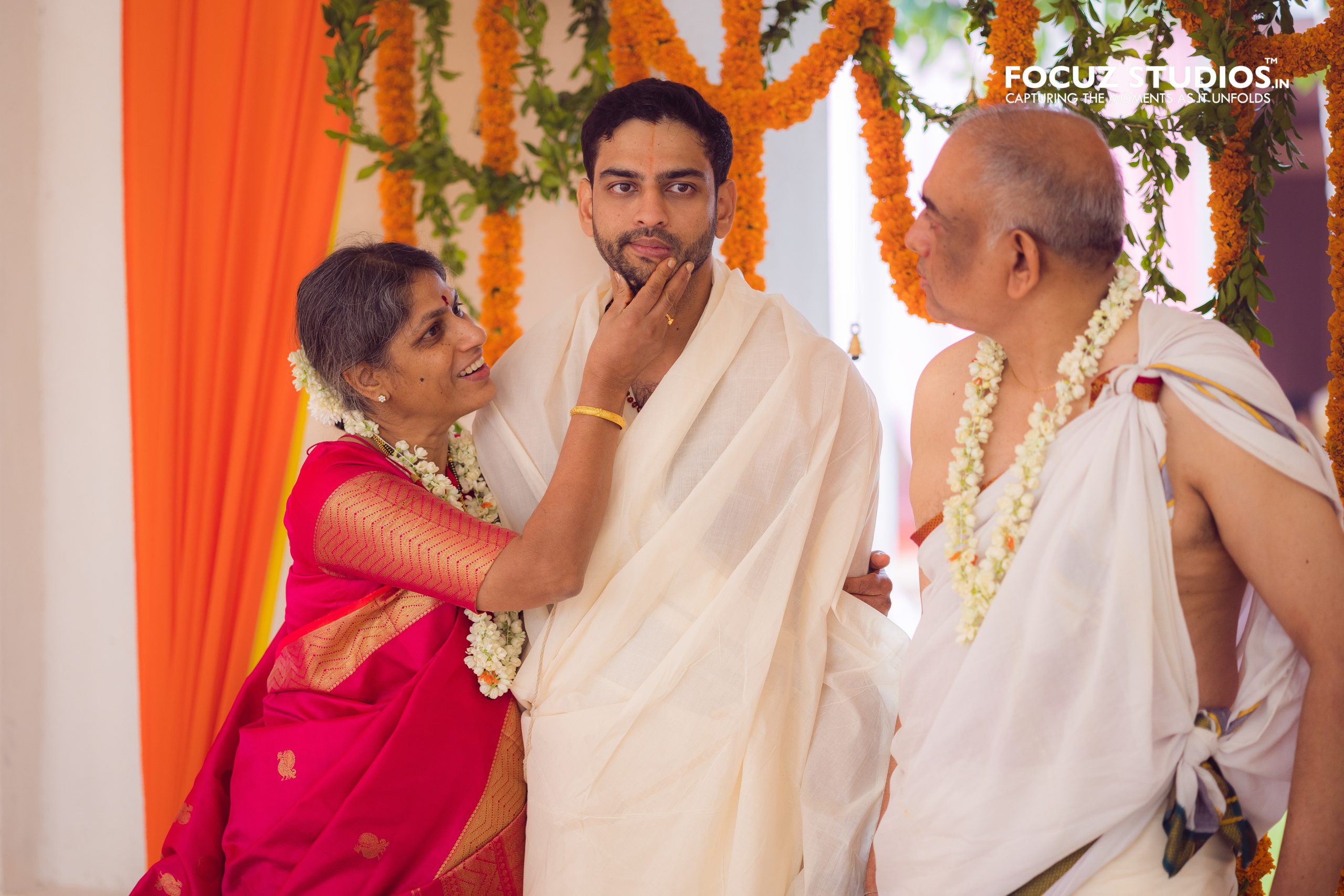 Groom seated with his parents before the rituals